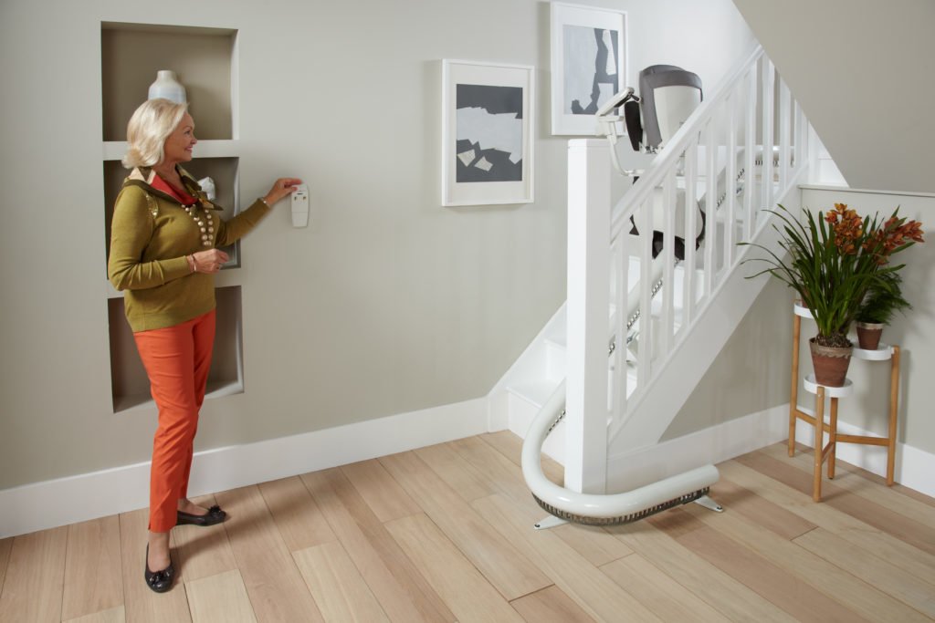 Woman Using a Stairlift- Stairlifts, Stairlift repairs, stairlift rentals in Cirencester, Newbury, Malmesbury,
